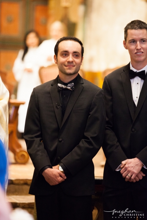 Santa Barbara Mission Wedding Groom Smiling as Bride Walks In Photo